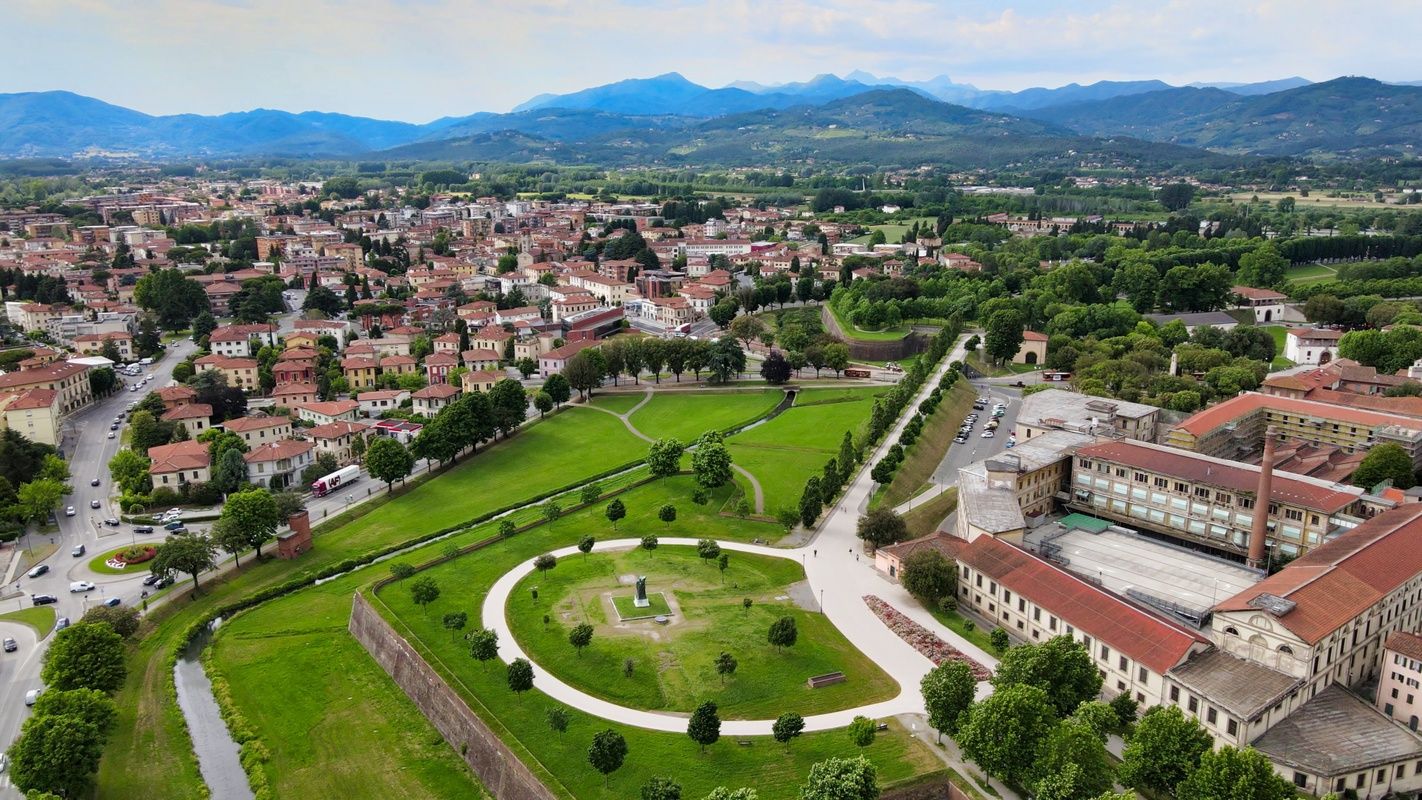 Lucca’s Renaissance walls and lush city park seen from above with Tuscan hills in the background..jpg