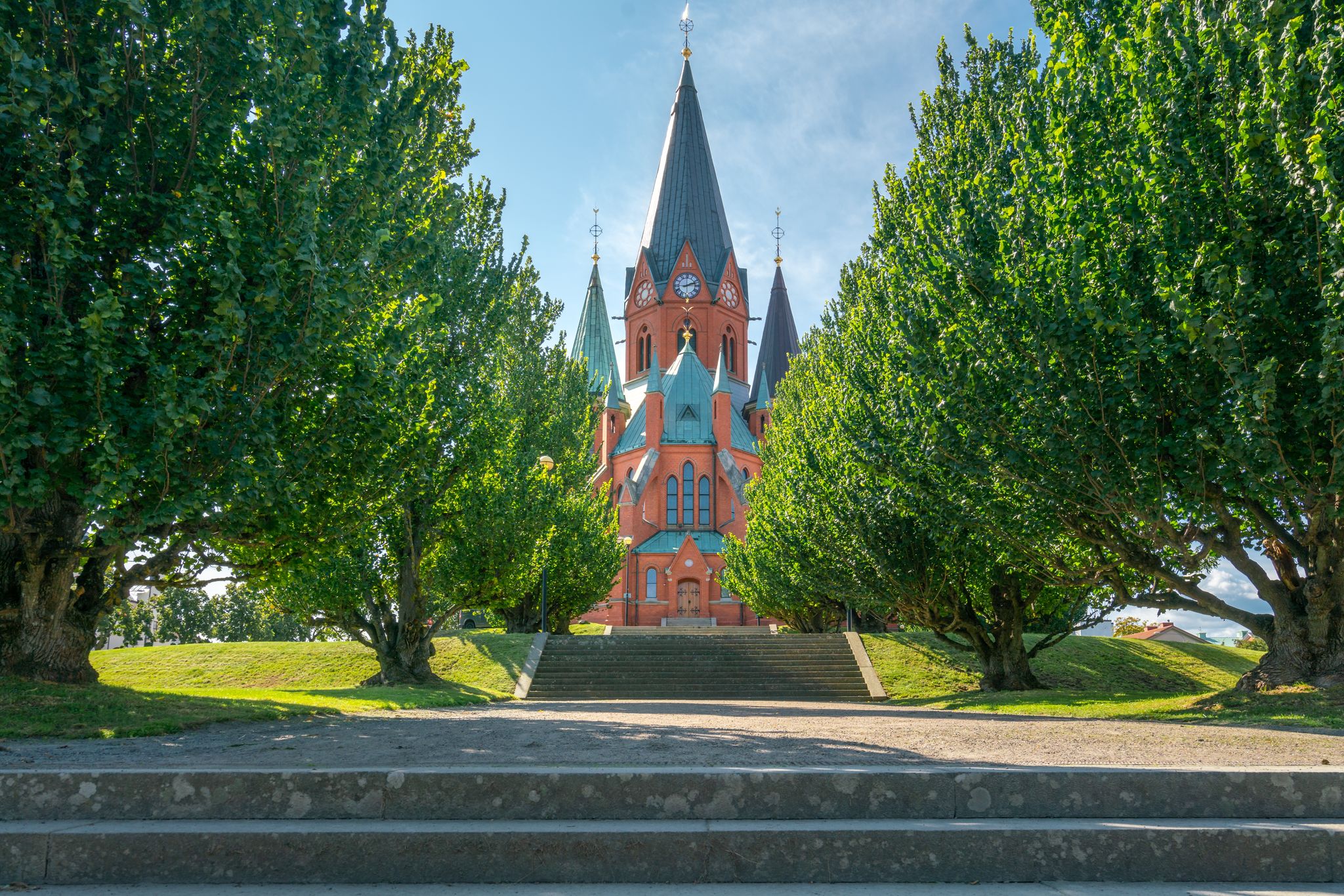 Red brick building of the Sankt Petri Kyrka, or Saint Peter Church, in Vastervik, Sweden, on a sunny summer day.