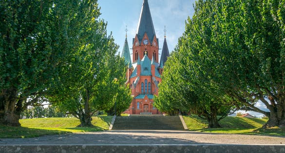 Red brick building of the Sankt Petri Kyrka, or Saint Peter Church, in Vastervik, Sweden, on a sunny summer day.