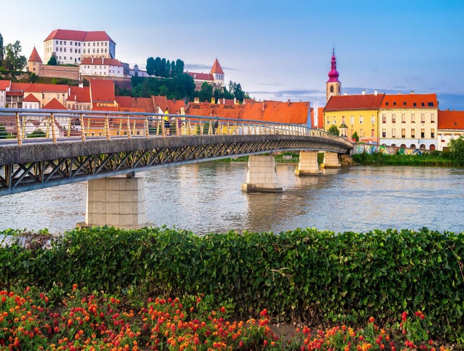Pedestrian bridge over the Drava River with historic architecture in the town of Ptuj, Slovenia..jpg