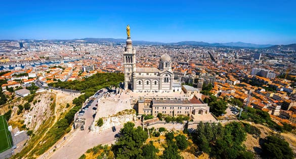 Photo of the aerial view of Basilique Notre-Dame-de-la-Garde in Marseille, a port city in southern France.