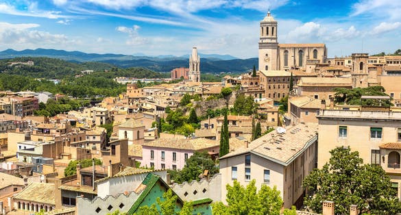 Photo of panoramic aerial view of Girona and cathedral in a beautiful summer day, Catalonia, Spain.