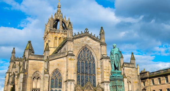 St. Giles' Cathedral aka High Kirk Church and Walter Scott Statue on High Street on Royal Mile in Old Town Edinburgh, Scotland, UK. Old town Edinburgh is a UNESCO World Heritage Site since 1995.