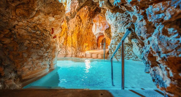 photo of view of Miskolc, Hungary - 3. june. 2022: Tourists enjoy at the cave with thermal water - natural SPA in Hungary at Miskolc Hungary. Rock tube with thermal water