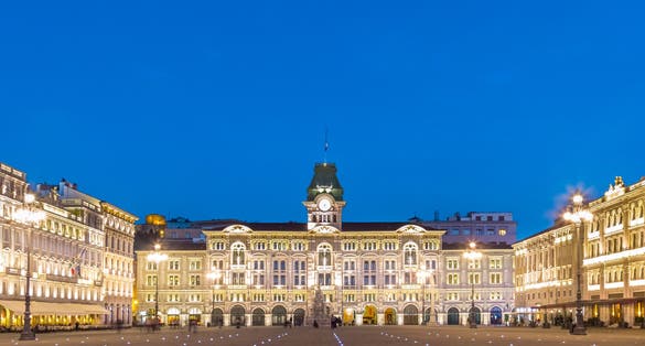 The City Hall, Palazzo del Municipio, is the dominating building on Trieste's main square Piazza dell Unita d Italia. Trieste, Italy, Europe. Illuminated city square shot at dusk.