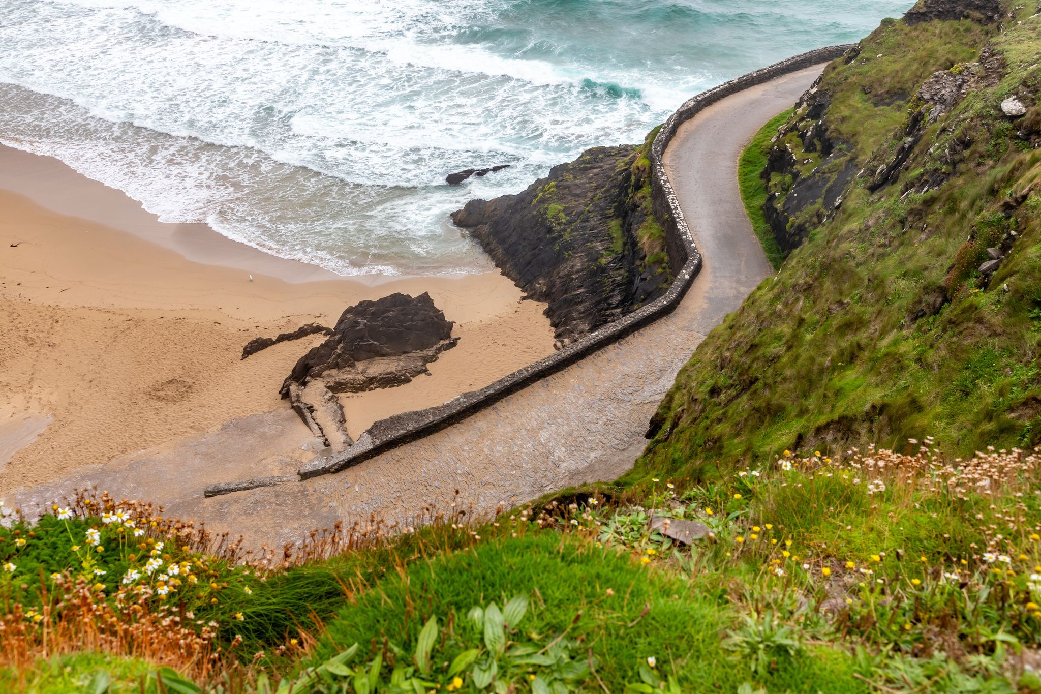 photo of Road to Coumeenoole beach with Cliffs and vegetation, Dingle, Kerry, Ireland .