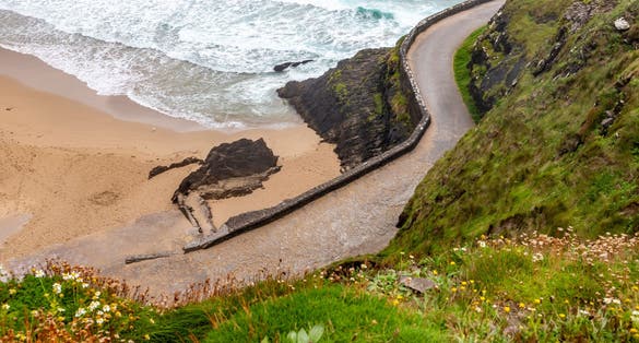 photo of Road to Coumeenoole beach with Cliffs and vegetation, Dingle, Kerry, Ireland .