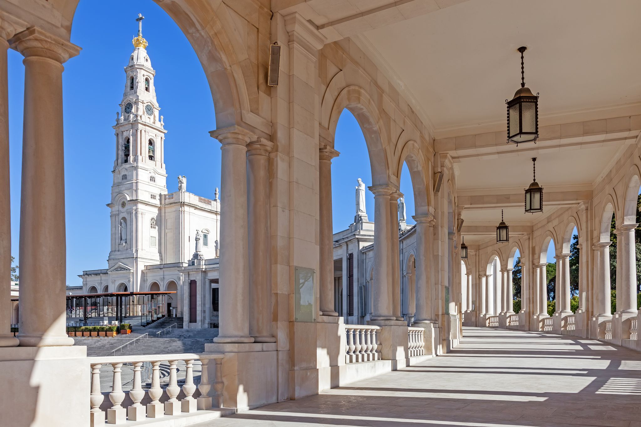 Photo of Sanctuary of Fatima, Portugal. Basilica of Our Lady of the Rosary seen from and through the colonnade.
