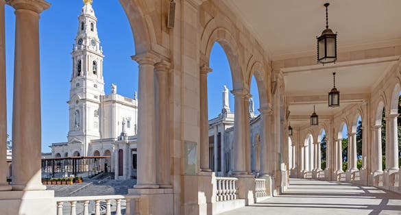 Photo of Sanctuary of Fatima, Portugal. Basilica of Our Lady of the Rosary seen from and through the colonnade.