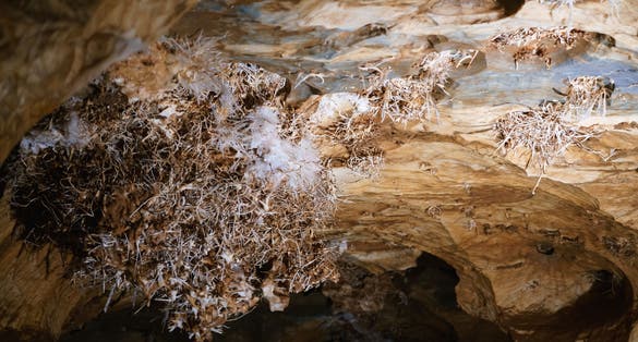 Photo of Unique and rare Ochtinská aragonite cave in the Slovak Karst inscribed on the UNESCO World Heritage List and its mineral.