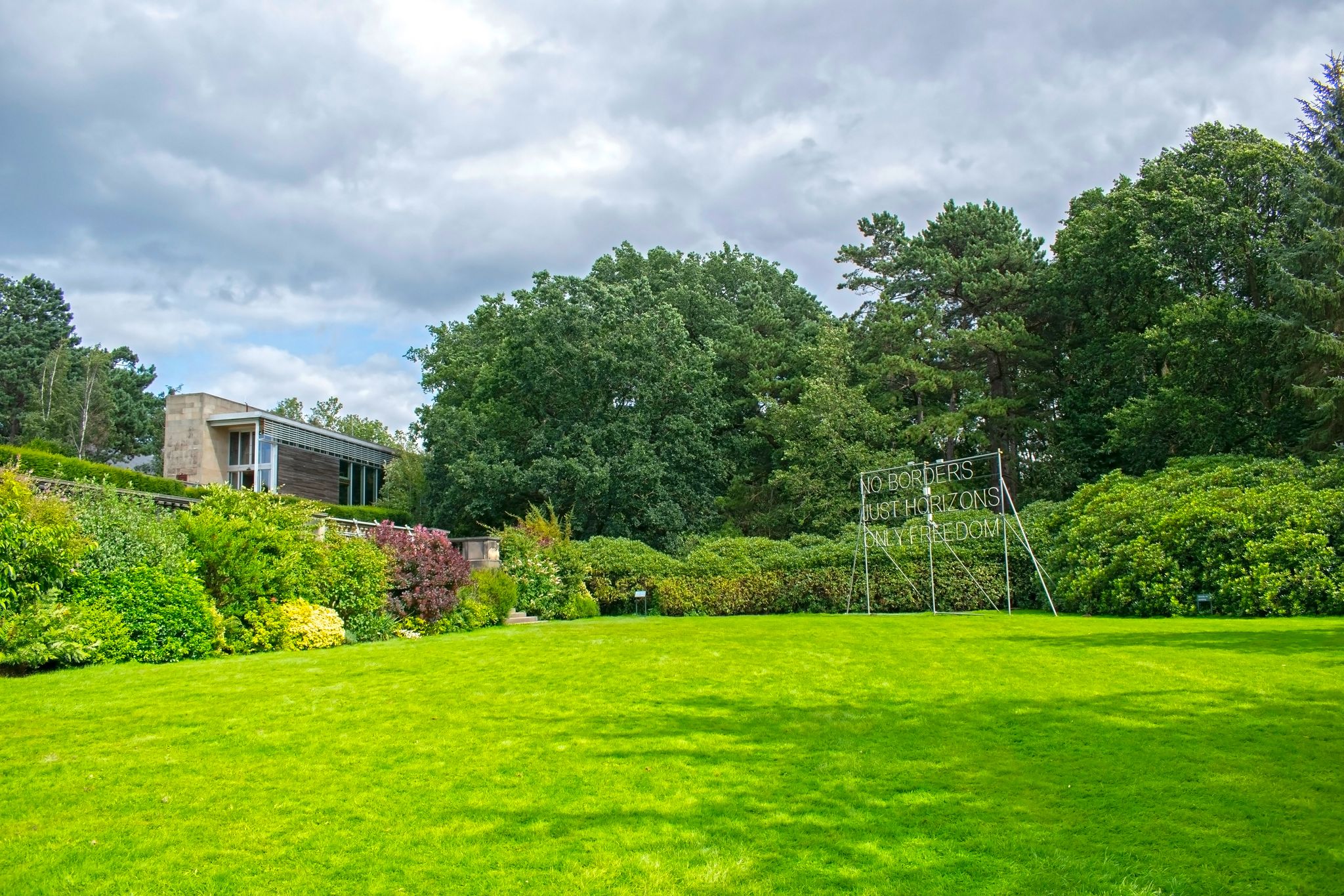 Photo of Yorkshire sculpture park, garden, "no borders just horizons only freedom" sign, Wakefield, England.