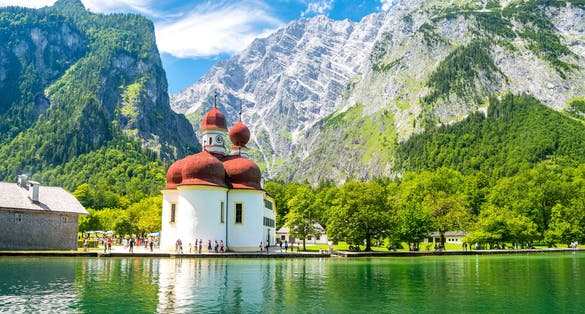 Photo of Konigsee lake with st Bartholomew church surrounded by mountains, Berchtesgaden National Park, Bavaria, Germany .