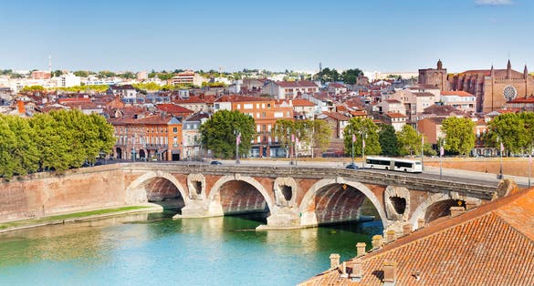Photo of Toulouse and Pont Neuf bridge across Garonne river, France.