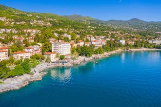 Photo of aerial view of beautiful town of Lovran, sea walkway in Kvarner bay coastline, popular tourist destination ,Croatia.