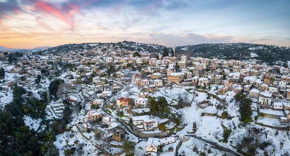photo of view Panoramic aerial view of the snow covered village of Lafkos, South Pelion, Greece, during a winter sunset, Pelion, Greece. 