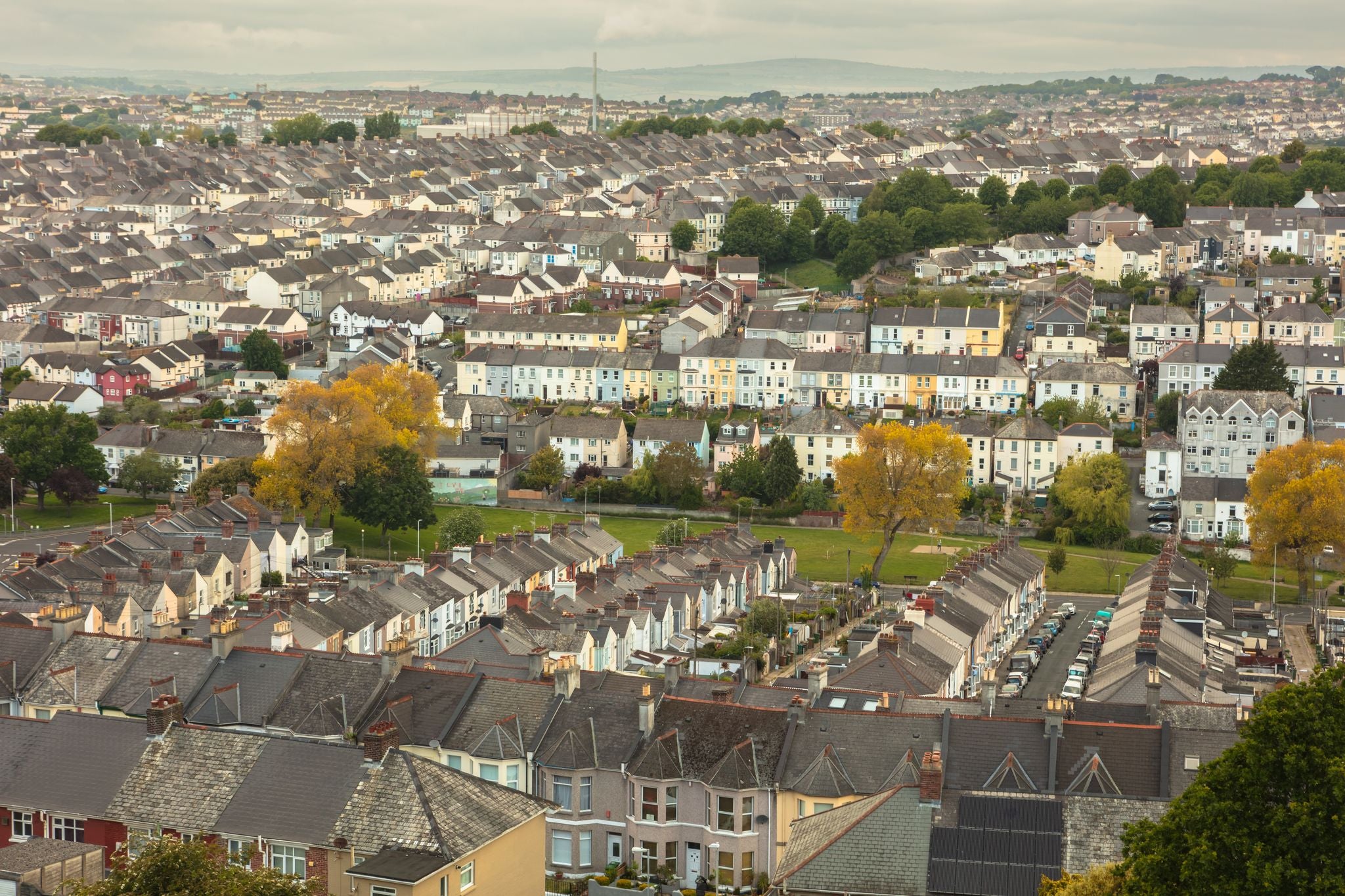 photo of view of View for miles over the townhouse and terraced housing of Plymouth, Devon, England, UK. Deprived area, social housing, urban