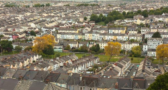 photo of view of View for miles over the townhouse and terraced housing of Plymouth, Devon, England, UK. Deprived area, social housing, urban