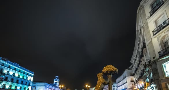 photo of Bear and strawberry tree statue in Puerta del Sol at night. Madrid, Spain.