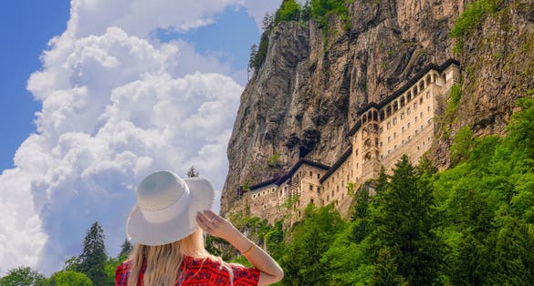 Photo of tourist woman watches Sumela Monastery in Trabzon, Turkey.