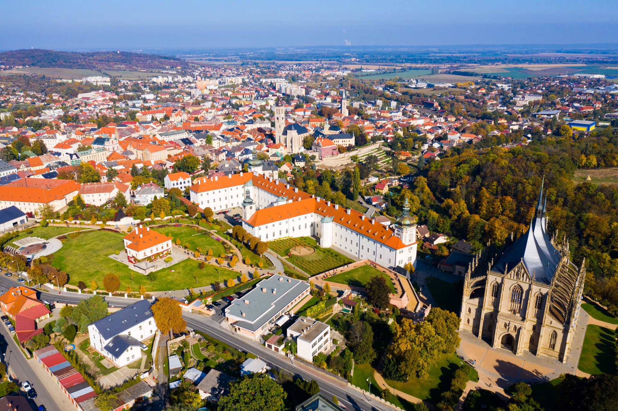 Photo of panoramic aerial view of Czech town of Kutna Hora overlooking medieval Jesuit College and St. Barbara Cathedral on sunny autumn day.