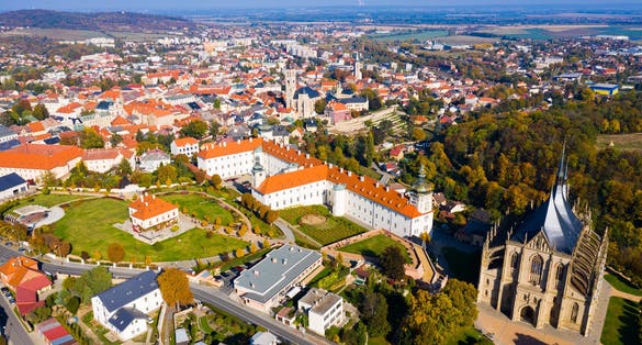 Photo of panoramic aerial view of Czech town of Kutna Hora overlooking medieval Jesuit College and St. Barbara Cathedral on sunny autumn day.