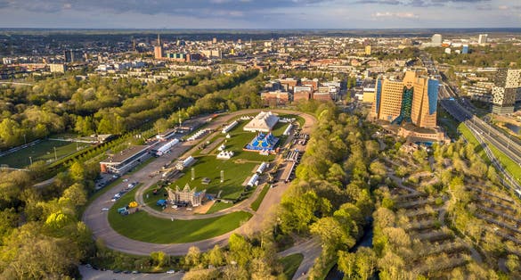 Aerial View of Groningen city Skyline from main park Stadspark area with festival builing up on racetrack event grounds, Netherlands