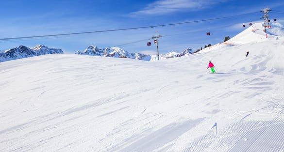 View to Ski slopes with the corduroy pattern and cable car on the top of Fellhorn Ski resort, Bavarian Alps, Oberstdorf, Germany