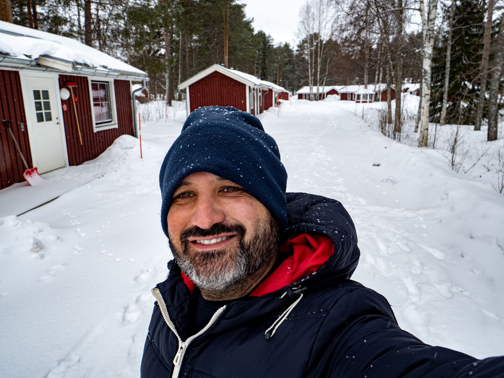 Smiling selfie in a snowy landscape in Sweden.