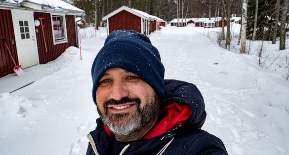 Smiling selfie in a snowy landscape in Sweden.