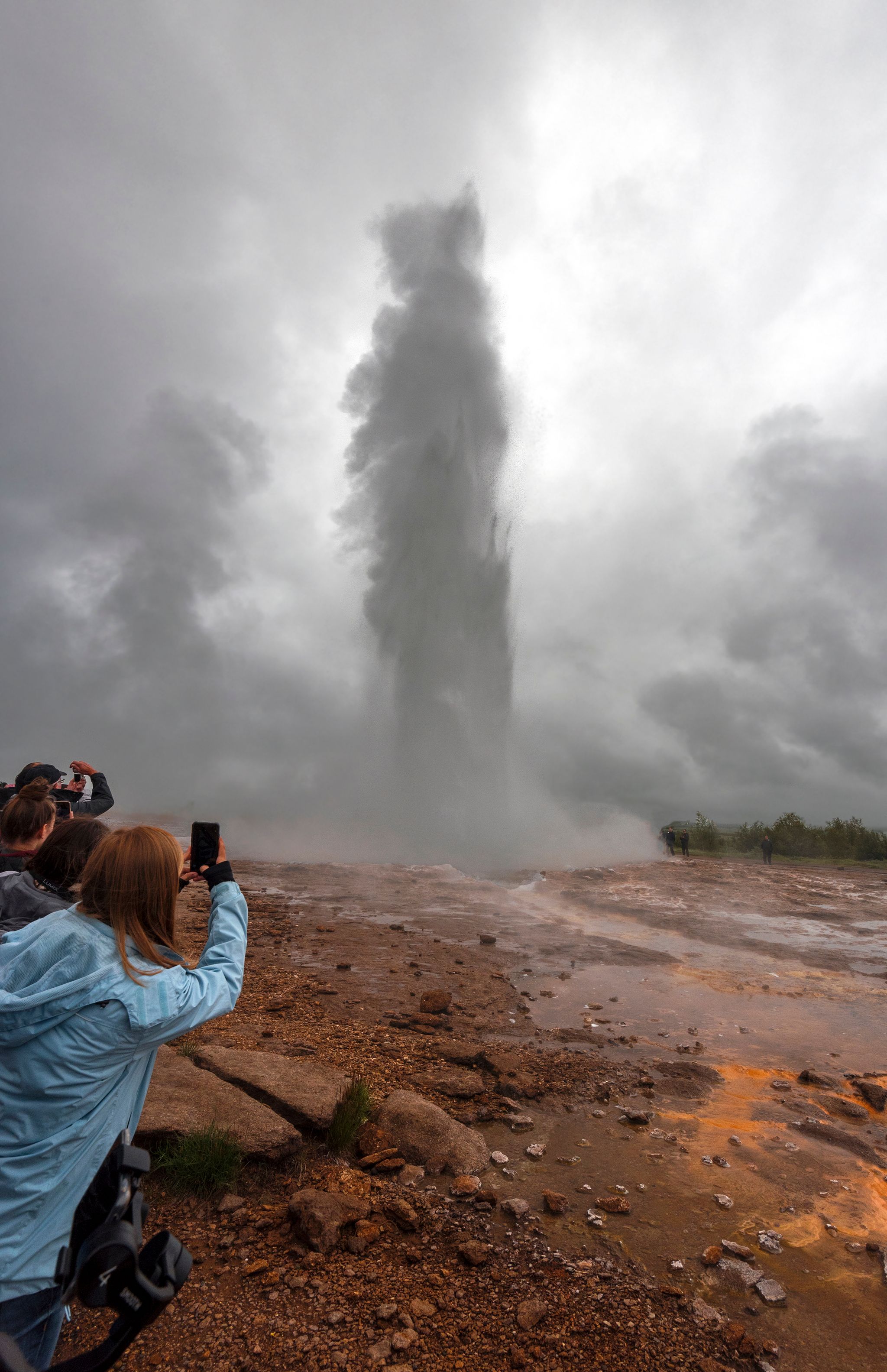 photo of geysir, Iceland. People recording the great geysir eruption in southwestern Iceland.
