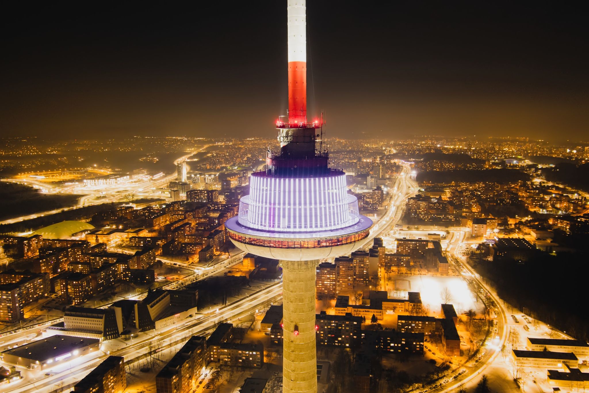 photo of aerial night view of illuminated Vilnius TV tower. Nightlife of Vilnius, Lithuania.