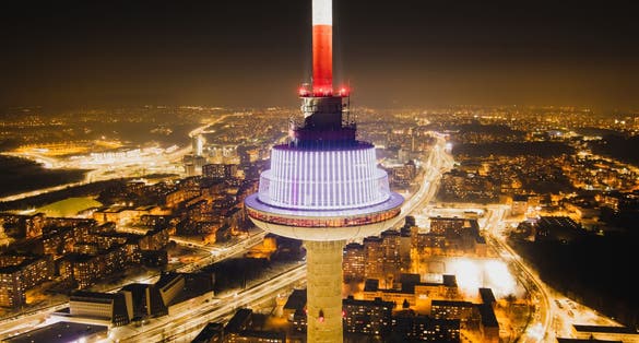 photo of aerial night view of illuminated Vilnius TV tower. Nightlife of Vilnius, Lithuania.