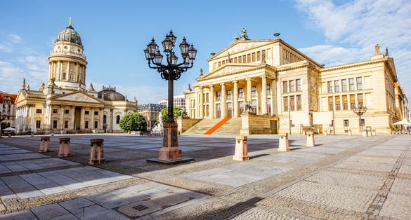 Photo of the Gendarmenmarkt square with concert house building and German cathedral during the morning light in Berlin city.