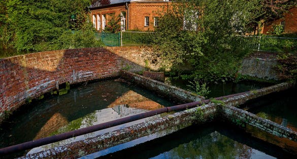 Photo of round water basin as part of the historic spinning and dyeing mill in Delmenhorst (Germany).
