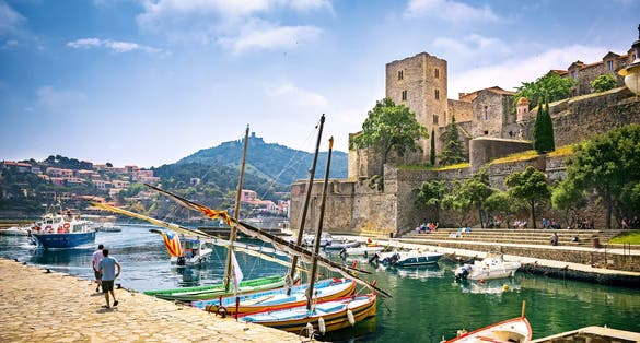 Photo of royal Castle (The Chateau Royal de Collioure), a massive French royal castle, and the harbour in the town of Collioure, France.