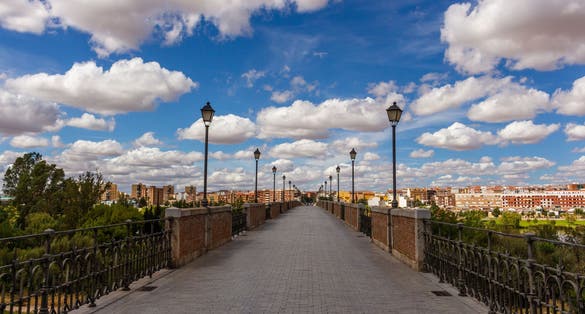 photo of a beautiful cloudy sky on the Puente de Palmas in Badajoz, Spain.