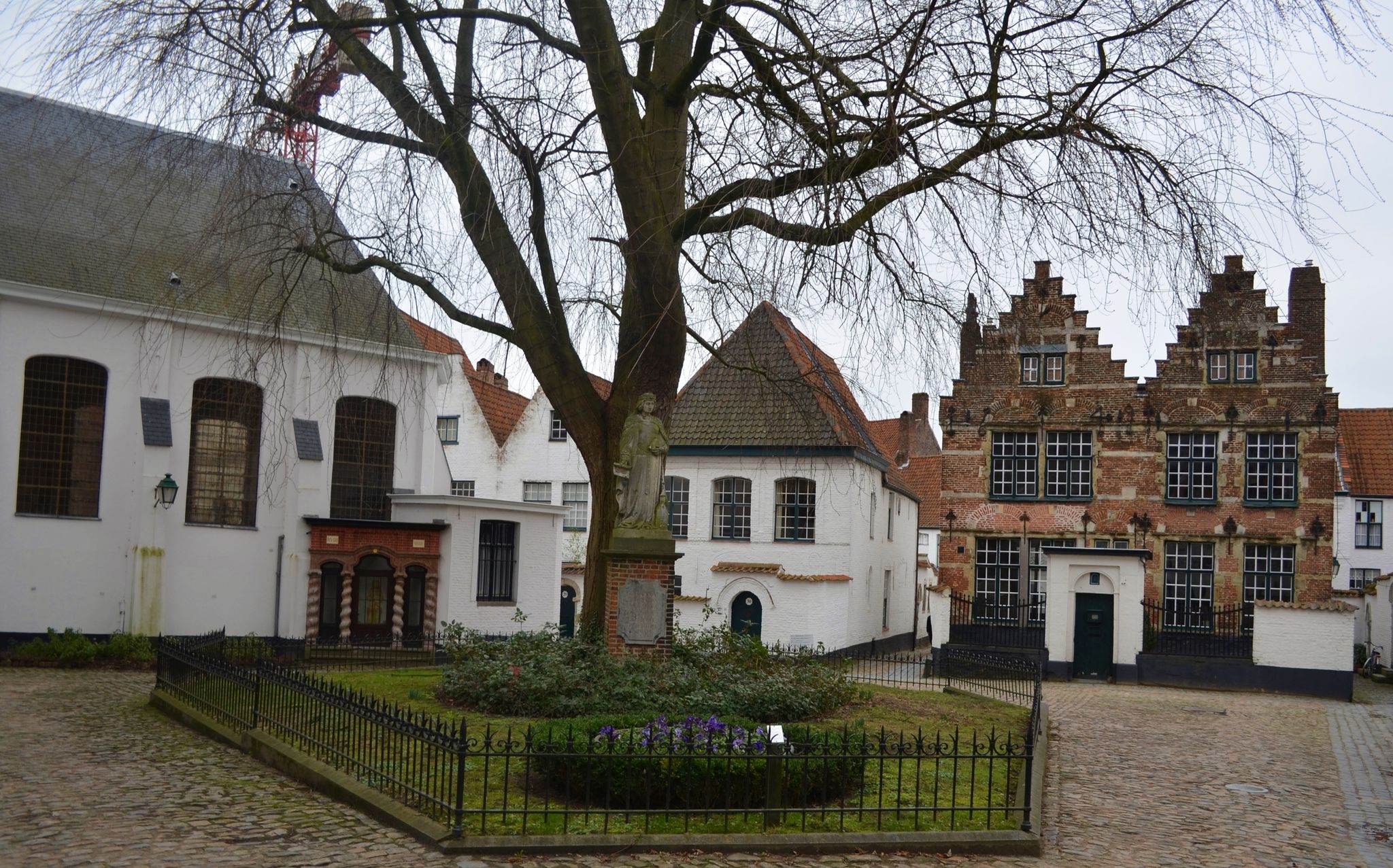 photo  of view  of White houses of local beguinage are one of the most remarkable attractions of belgian city kortrijk/courtrai.