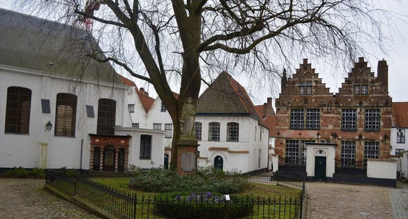 photo  of view  of White houses of local beguinage are one of the most remarkable attractions of belgian city kortrijk/courtrai.