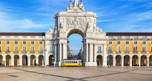 Photo of Praca do Comercio with yellow tram, Lisbon, Portugal.