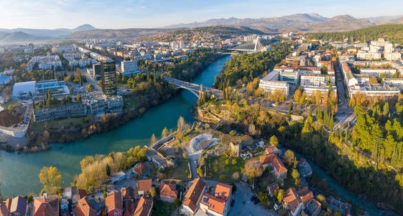 Photo of Confluence of Ribnica and turquoise Moraca river, flowing through downtown Podgorica, Montenegro.
