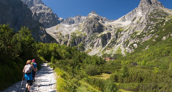 Photo of Tourists approaching to the chalet at Zelene pleso, High Tatras, Slovakia.