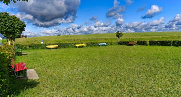 Photo of Scenic view of public park with colorful benches at viewpoint of Zürich Airport on a sunny spring day. Photo taken May 28th, 2024, Kloten, Switzerland.