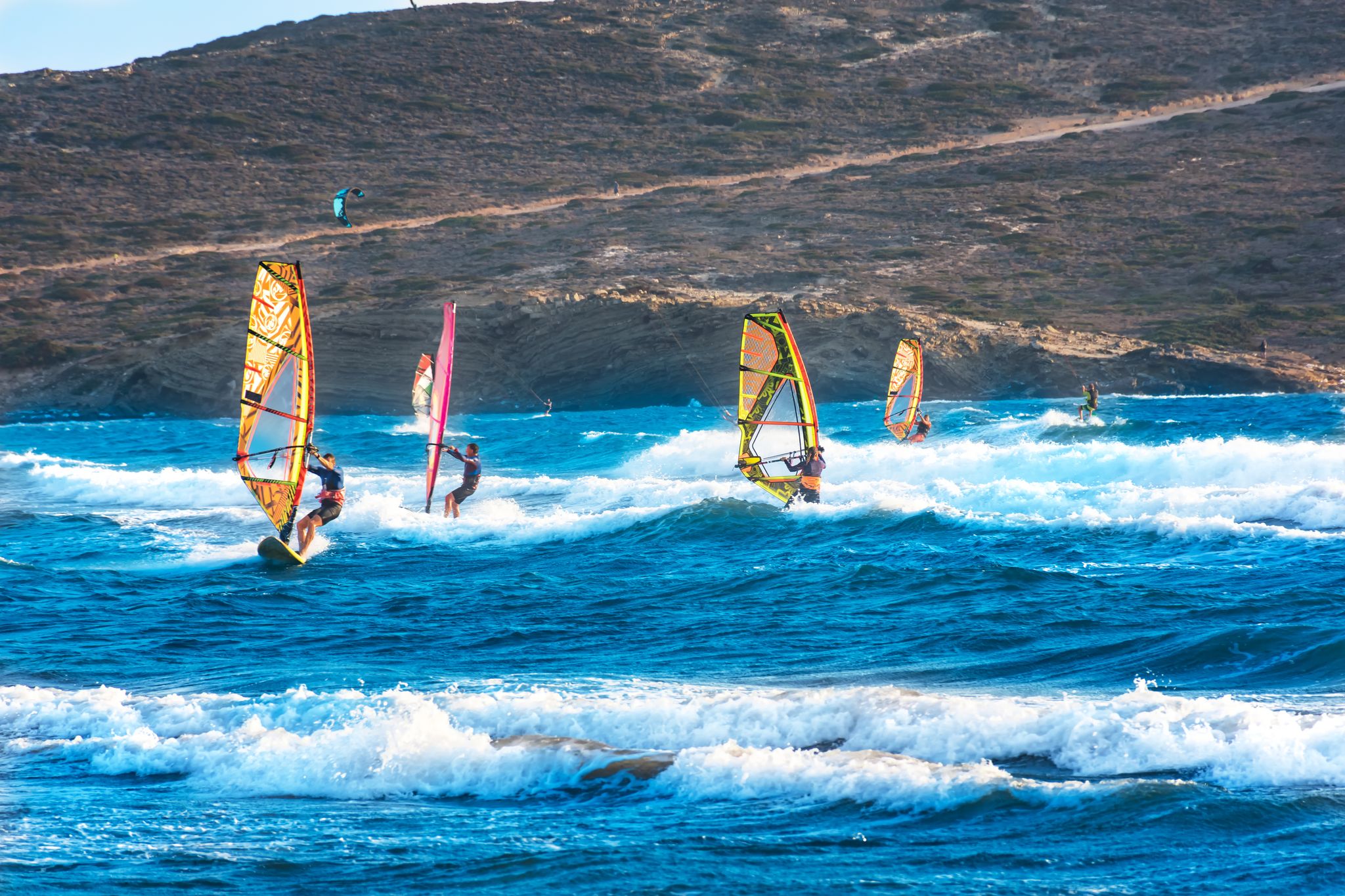 photo of view of Windsurfers and kitesurfers ride on Prasonisi beach (Rhodes, Greece).