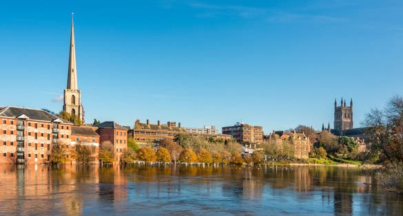 Flood and swans by Worcester bridge Worcestershire UK