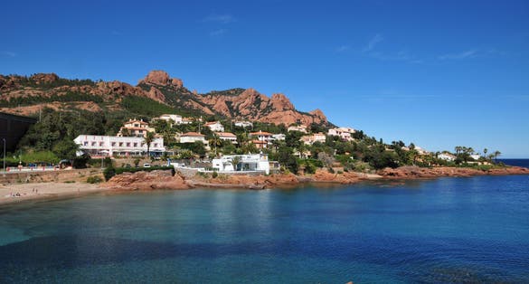 Esterel mediterranean red rocks coast, beach, tree and sea. French Riviera in Cote d Azur near Cannes Saint Raphael, Provence, France, Europe.