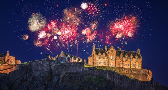 The castle of Edinburgh with fireworks during Hogmanay.