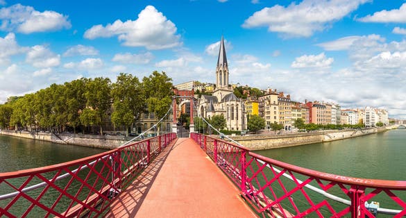 Photo of Pedestrian Saint Georges footbridge and the Saint Georges church in Lyon, France.