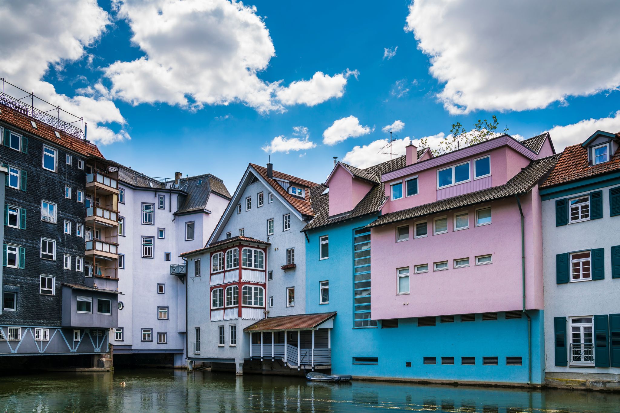 Photo of Germany, Esslingen am neckar, little venice, colorful houses along riverside of neckar river with a rubber boat in summer .