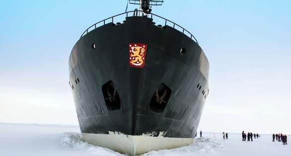 Kemi, Lapland, Finland - Tourists boarding the Arctic icebreaker ship Sampo on the frozen Gulf of Bothnia. The retired icebreaker (built 1961) now takes tourist cruises in winter.