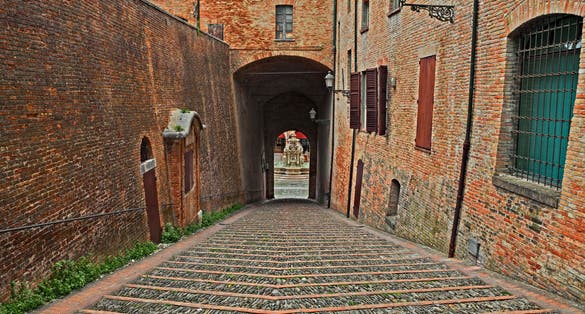 Photo of old staircase and underpass leading to the main city square with the ancient fountain, Cesena, Emilia-Romagna, Italy.